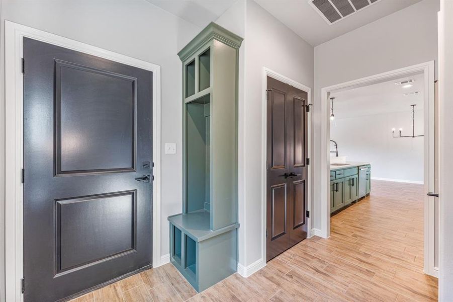 Mudroom with sink and light hardwood / wood-style flooring