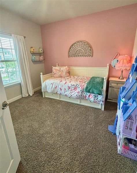 Bedroom featuring dark colored carpet