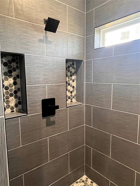 Bathroom featuring a tile shower