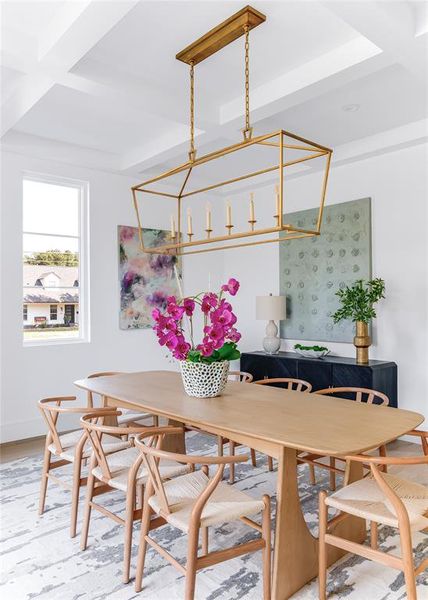 Dining room with coffered ceiling, hardwood / wood-style flooring, and a chandelier