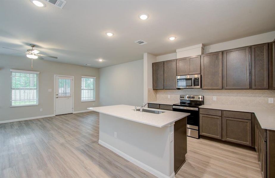 Open concept kitchen/dining/family room located on first floor