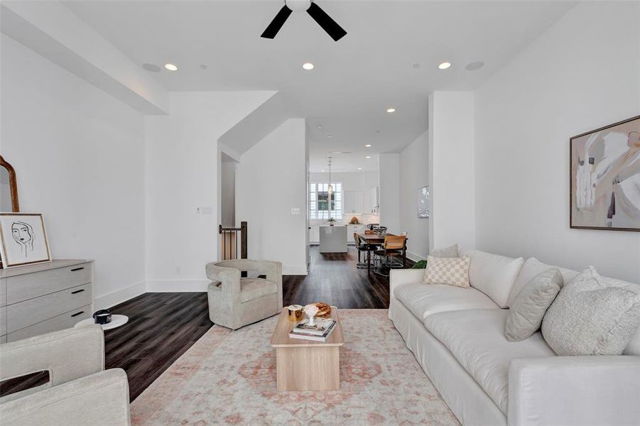 This view of the living room, from the patio area, shows the nearby dining room and kitchen spaces.