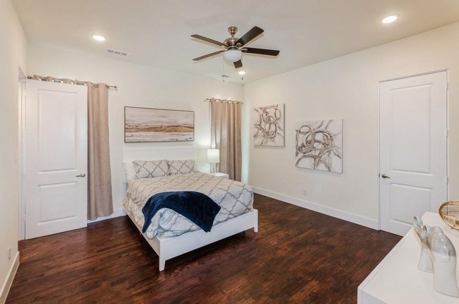 Bedroom featuring ceiling fan and dark hardwood / wood-style floors