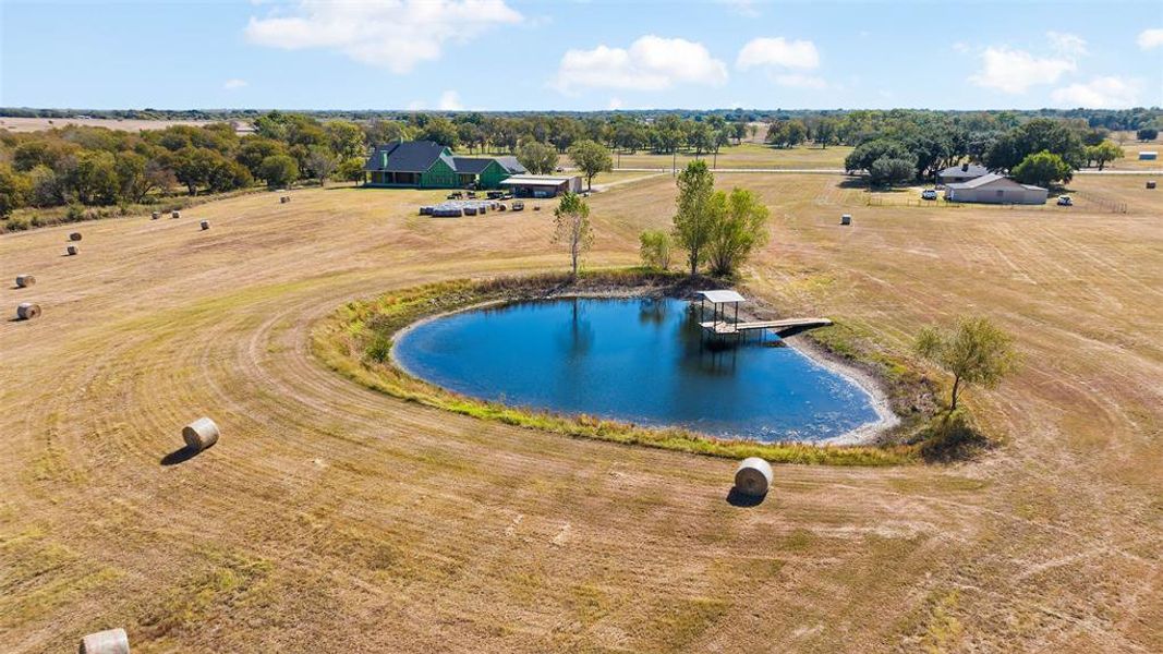 View of swimming pool with a water view and a rural view