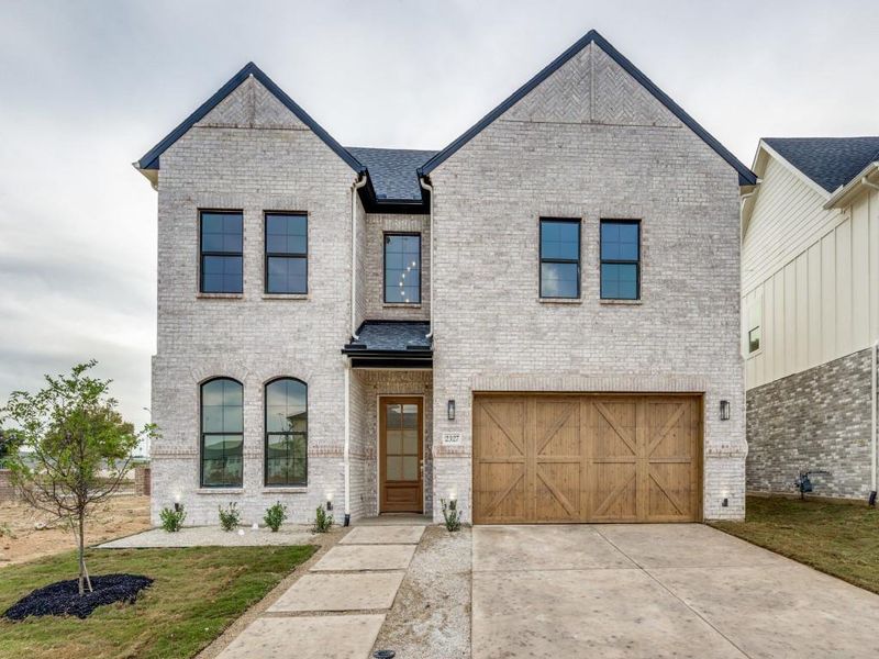 French provincial home with a garage