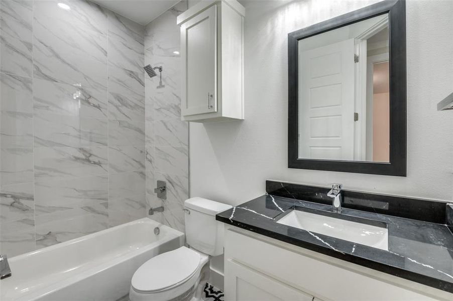 Guest Bathroom - Floor to ceiling tile with beautiful patterned floor tile, upgraded counter top and elongated toilets in all bathrooms!