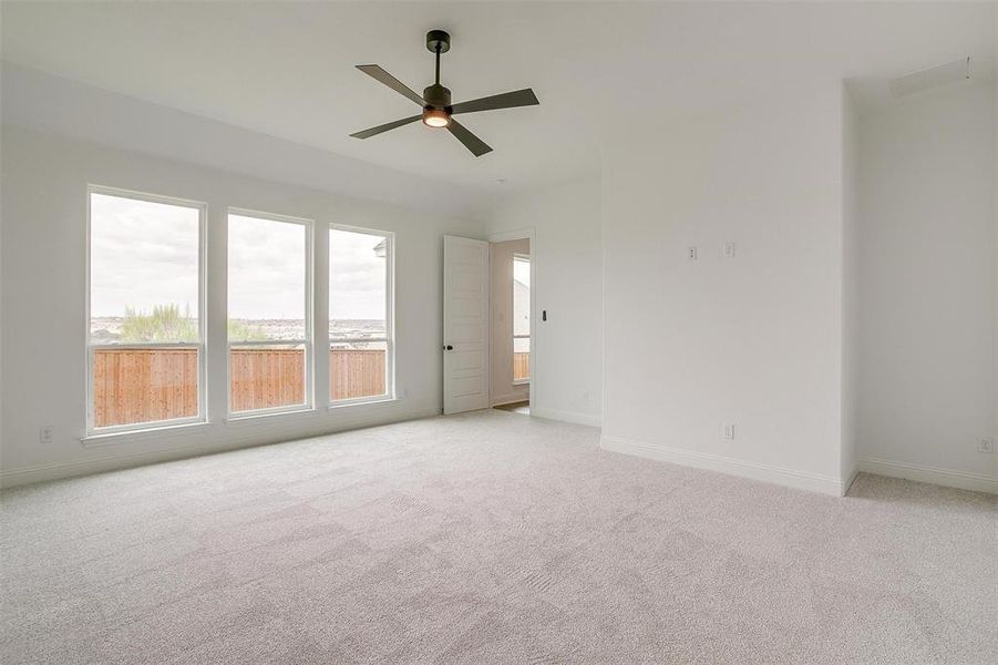 Unfurnished room featuring light carpet and ceiling fan