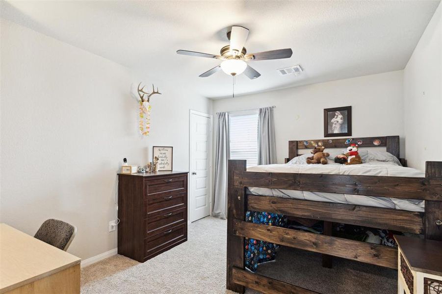 First of the 3 bedrooms upstairs. It offers a ceiling fan, large window, and a walk in closet.