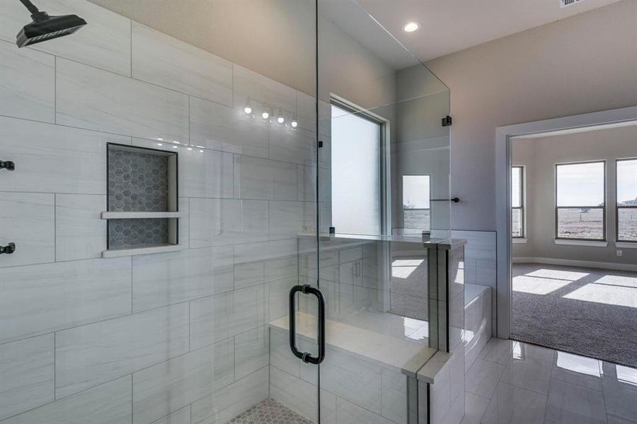 Bathroom featuring walk in shower and tile patterned flooring