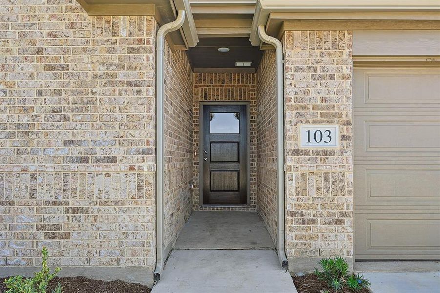 Doorway to property with a garage