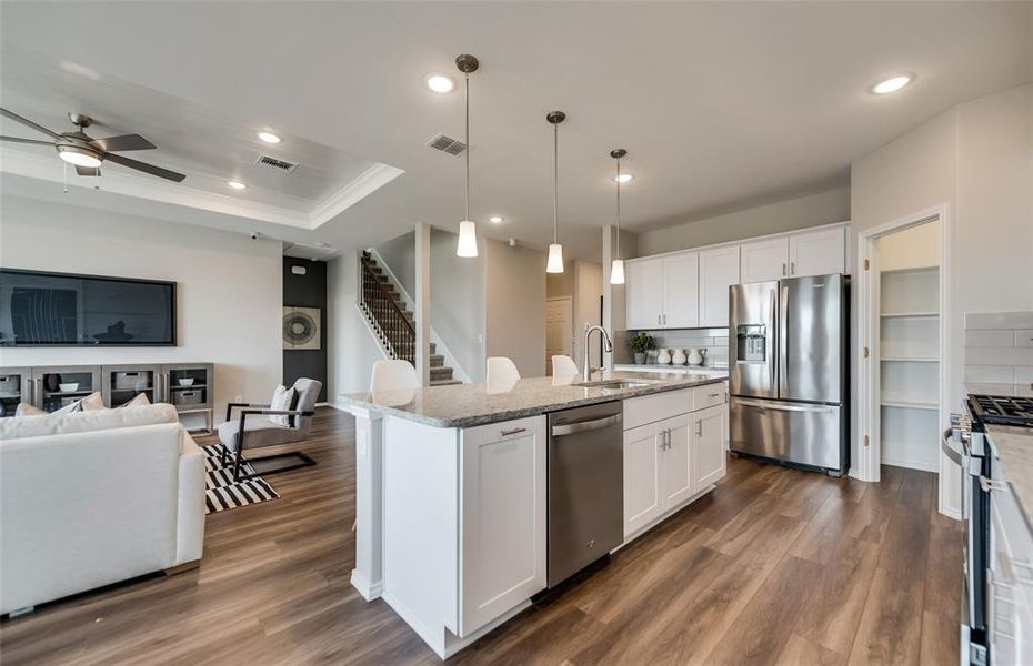 Bright kitchen with an expansive center island perfect for gatherings  *Photos of furnished model. Not actual home. Representative of floor plan. Some options and features may vary