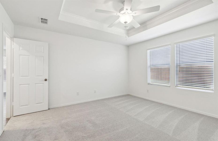 Elegant tray ceiling in owner's suite *real home pictured