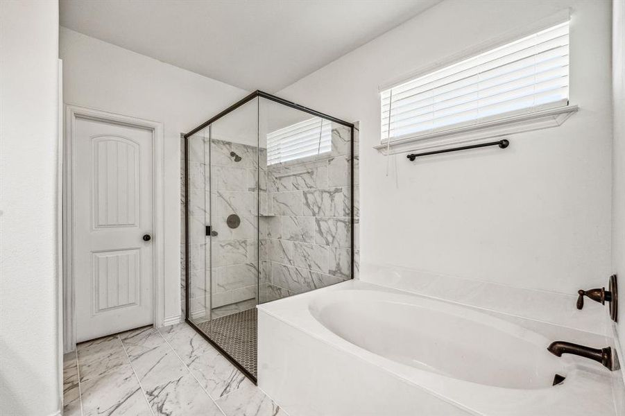 Bathroom featuring tile patterned floors and separate shower and tub