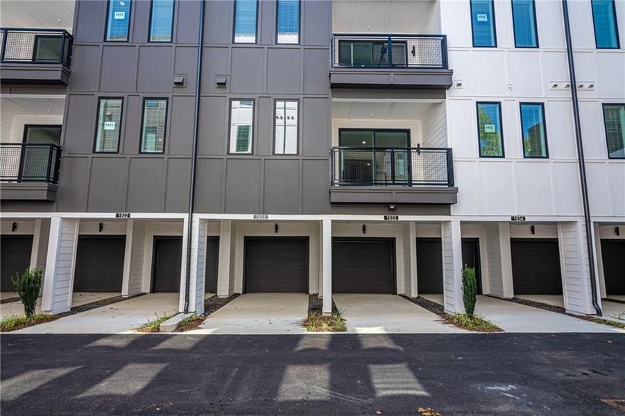 No parking deck here! Private garage with covered carport for each home. 220 outlet for your EV included