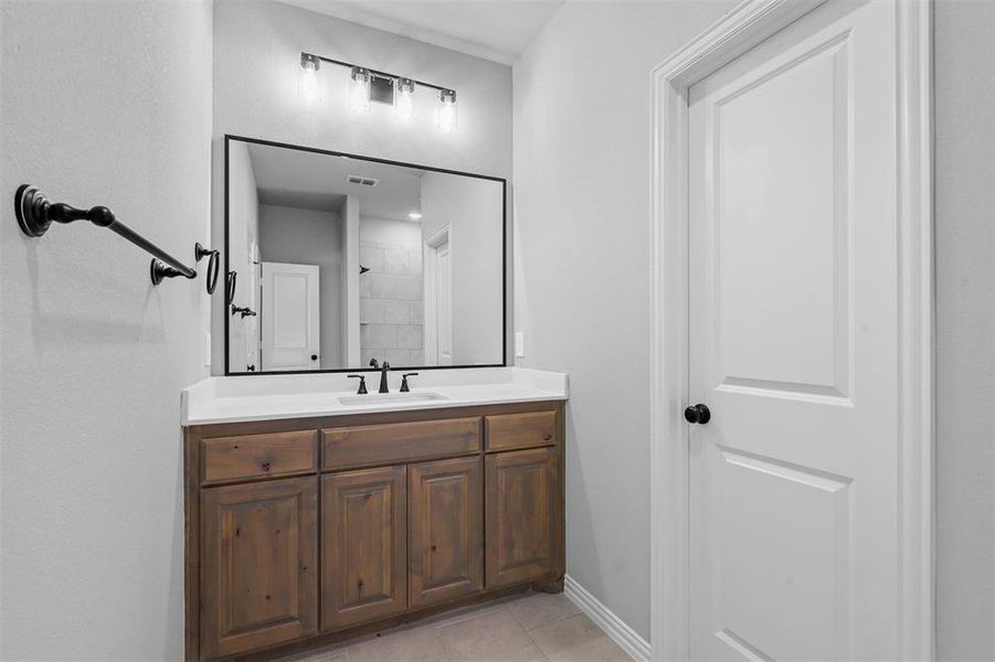 Bathroom with tile patterned flooring and vanity