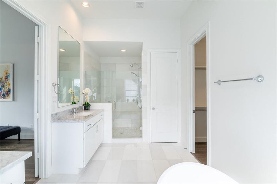 Freestanding shower in the Primary bathroom with double wrap around bench seat and Hans Grohe plumbing fixtures.  (similar home and features)