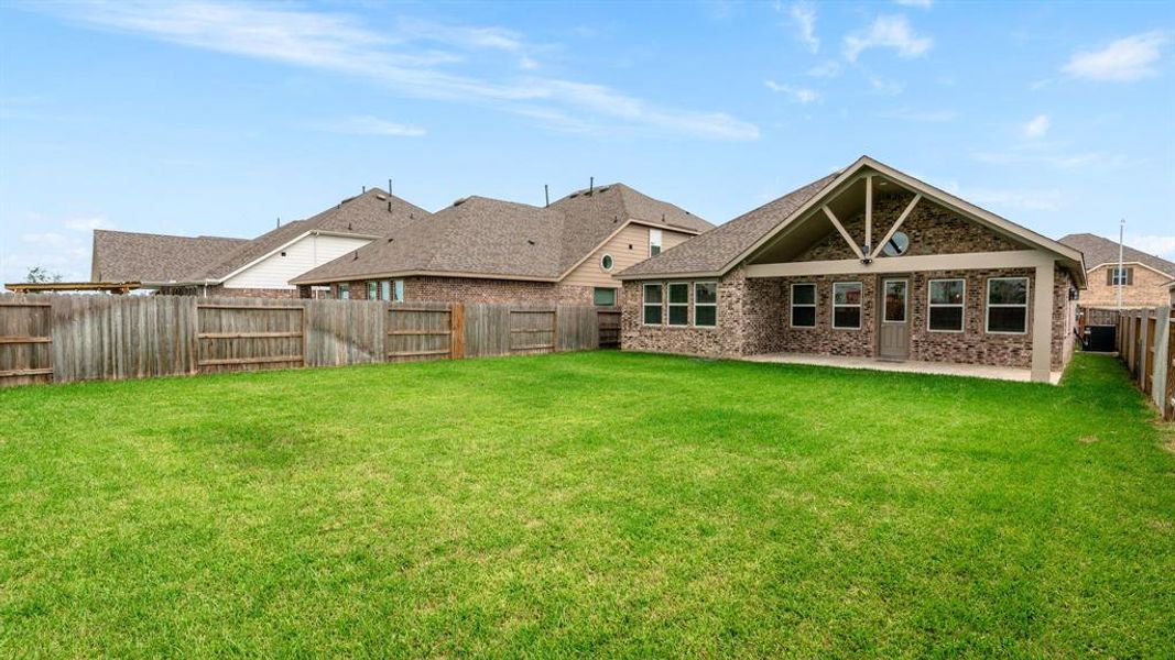 Brick on all sides with a  large patio area.  Room for a pool too!