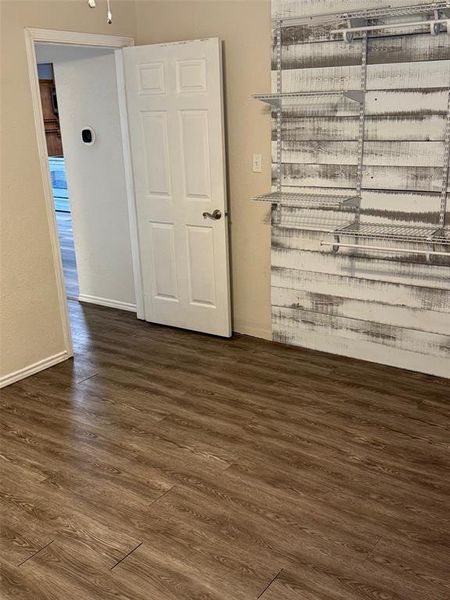 Empty room featuring dark wood-type flooring