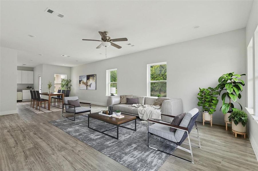 Living room featuring ceiling fan and light hardwood / wood-style floors