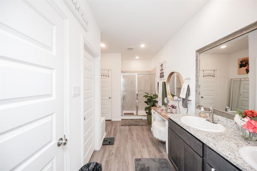 The master bathroom is really big! You will enjoy the double sinks, granite counters, framed mirror, and updated plumbing fixtures.