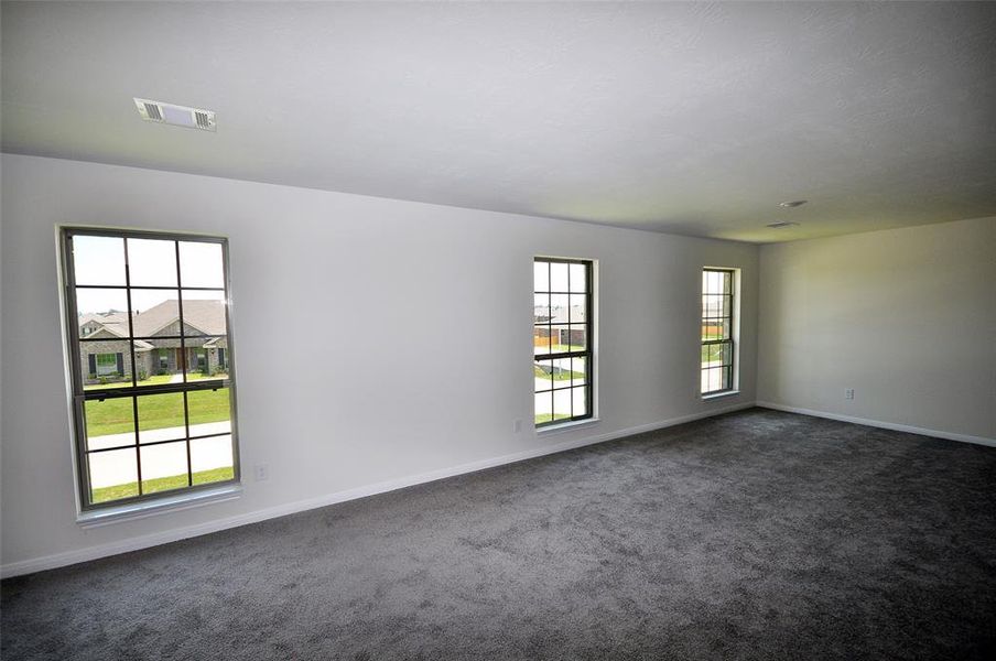 L shaped game room on the second floor has multiple sitting areas.