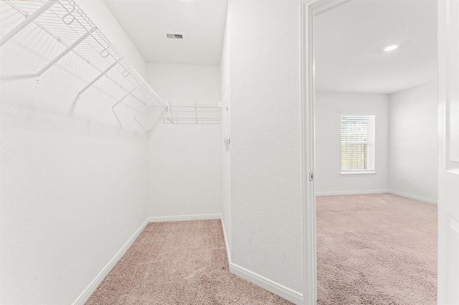 There will be no fighting for closet space in this very long primary walk-in closet.