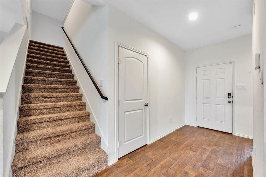 The entryway takes you through the hallway to the living, dining, and kitchen. the walkway to the right leads you to a secondary bedroom, bath, and utility room. The stairs take you to the second floor flex space and two more bedrooms and a bath.