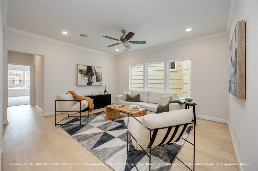 The second-story game room, a realm of leisure nestled between the serenity of the primary suite and the charm of a secondary bedroom, brightened by an expansive wall of windows.