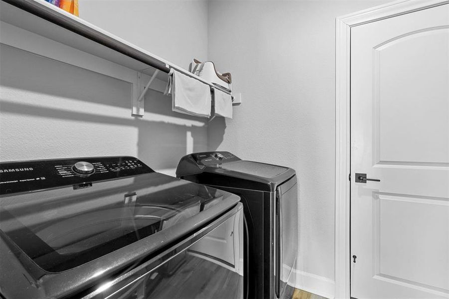 Laundry area featuring hardwood / wood-style floors and washer and clothes dryer