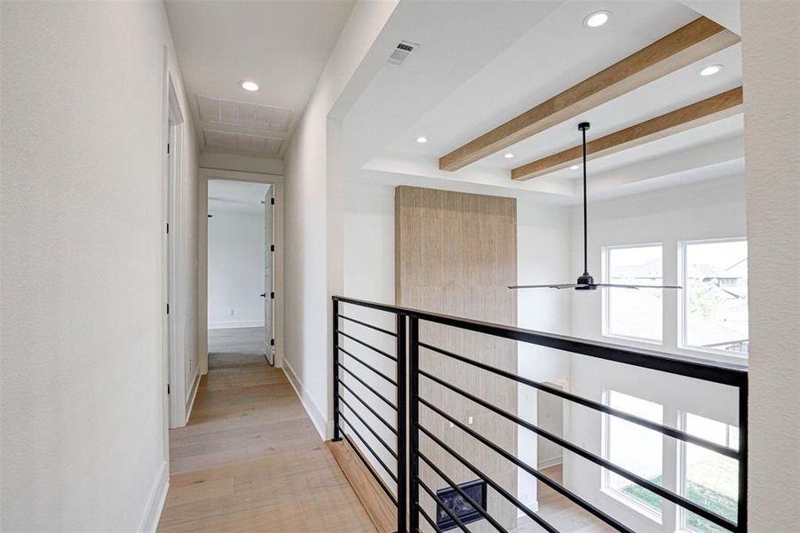 Hall featuring light hardwood / wood-style flooring and beam ceiling