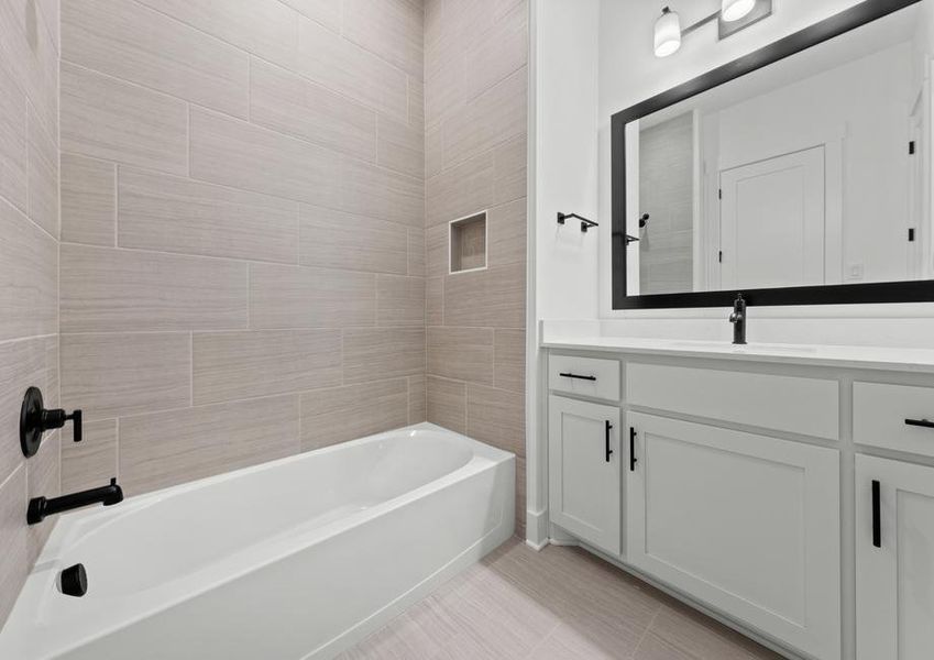 The secondary bathroom has a large vanity with plenty of cabinet space and a shower-tub combo.