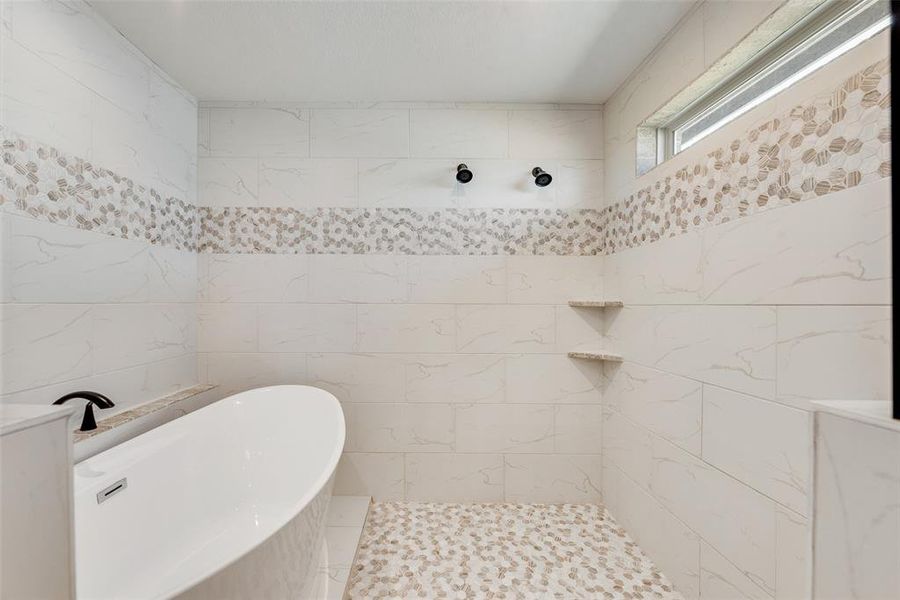 Bathroom with tile walls and tiled shower