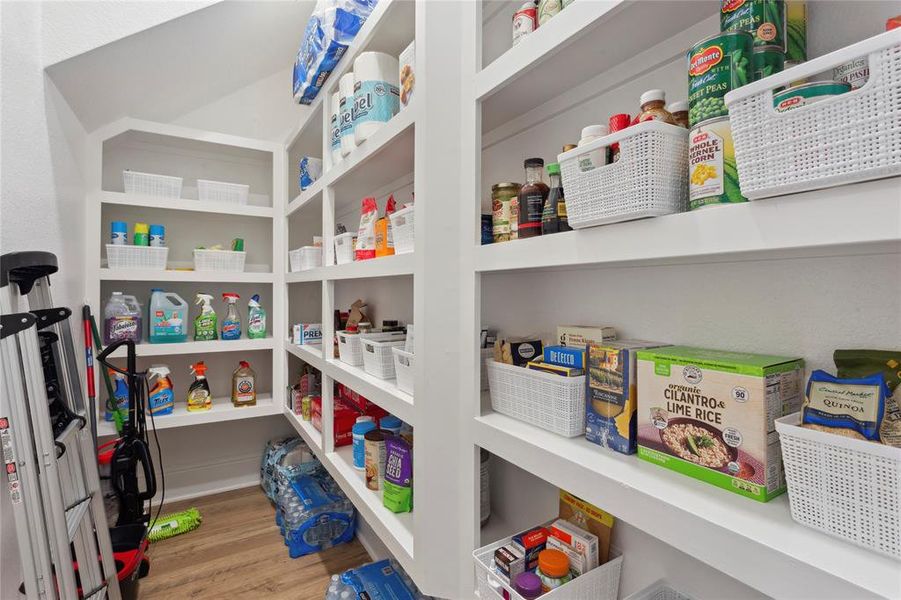 Tucked behind the kitchen is spacious walk-in pantry with doorjam light sensor