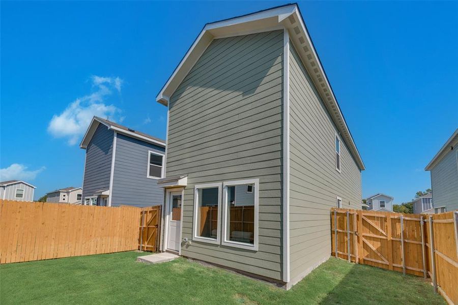 Rear view of house with a yard