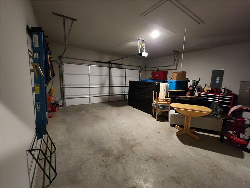 Garage featuring a garage door opener