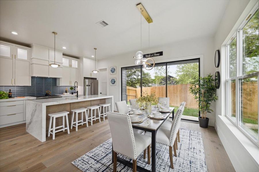 Open kitchen seamlessly flows into the dining area, creating a modern, airy space ideal for entertaining.