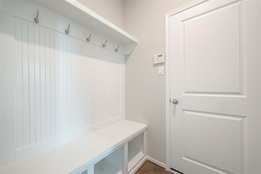 Keep things organized with the mudroom built-in hanging racks and storage.