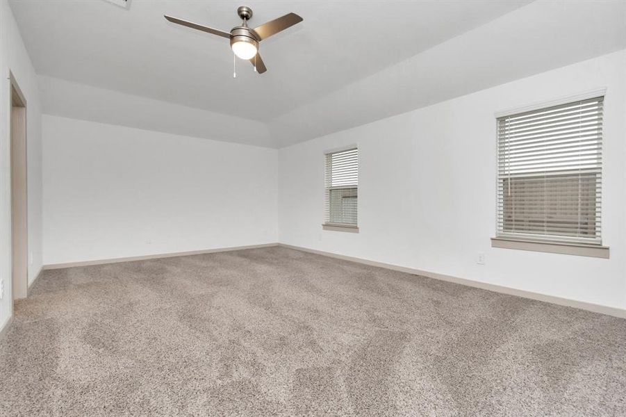 Spacious Primary Suite with windows overlooking the backyard