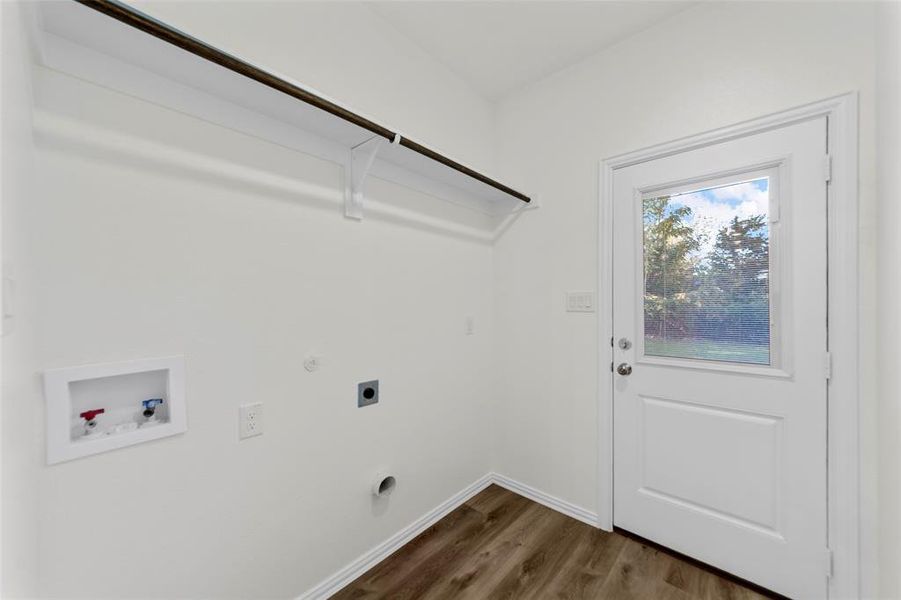 Laundry area featuring washer hookup, hookup for an electric dryer, dark hardwood / wood-style floors, and hookup for a gas dryer