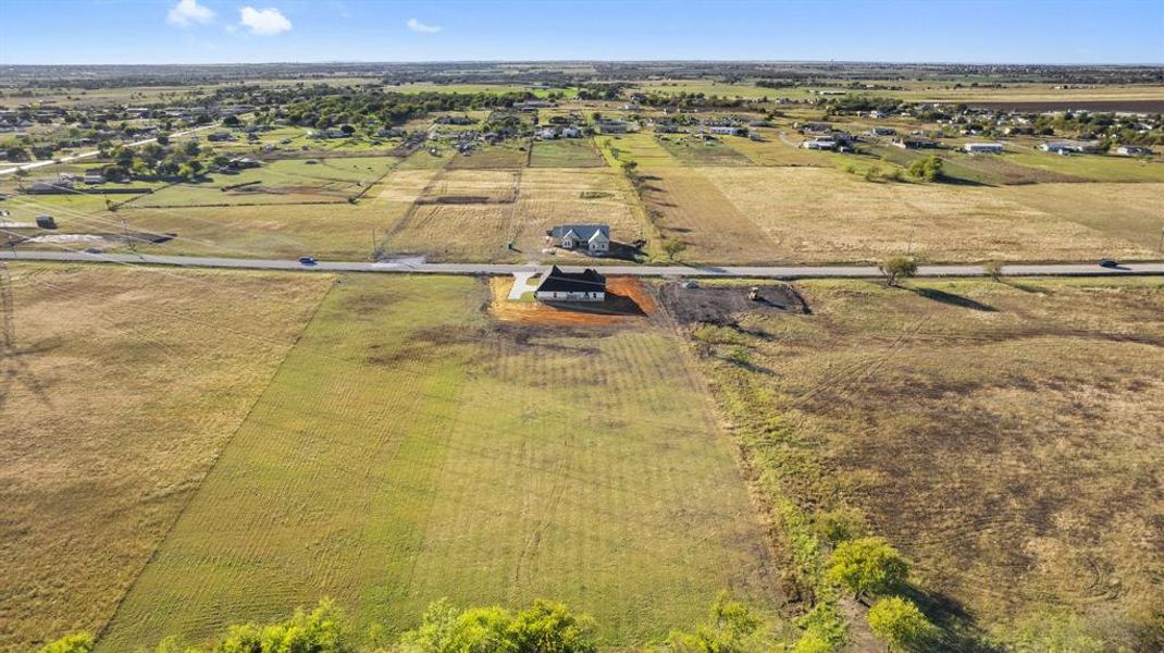 Birds eye view of property featuring a rural view