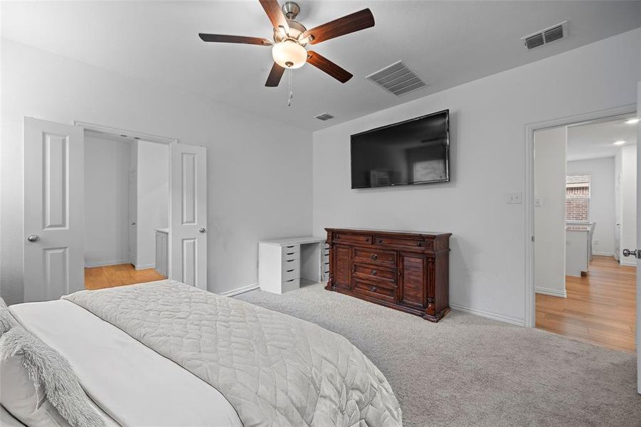 Carpeted bedroom featuring ceiling fan