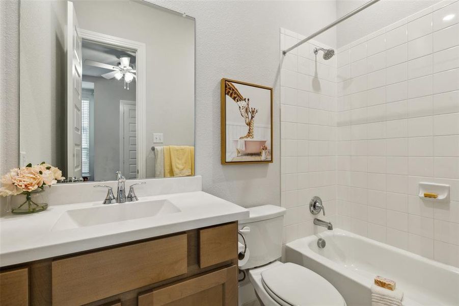 Full bathroom downstairs with tile flooring.