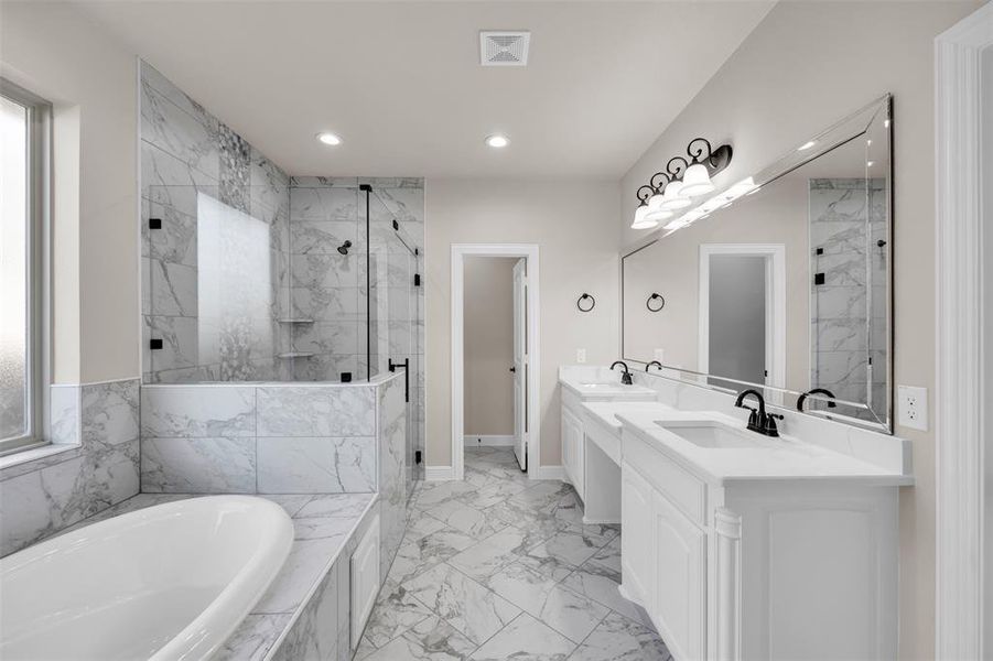 Bathroom featuring vanity and plus walk in shower