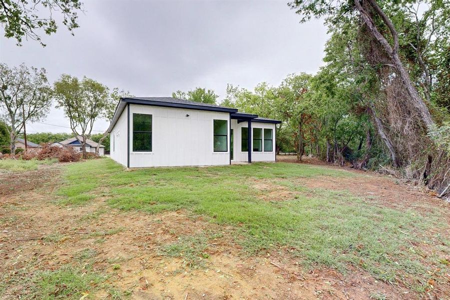 Rear view of house with a yard