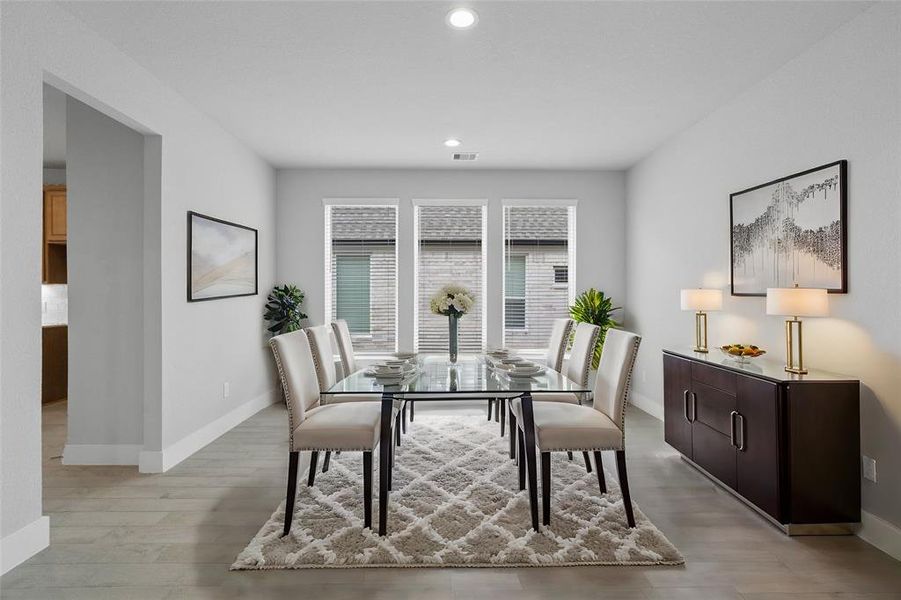 Make memories gathered around the table with your family and friends! This dining room features high ceilings, custom paint, recessed lighting, and large windows with privacy blinds.