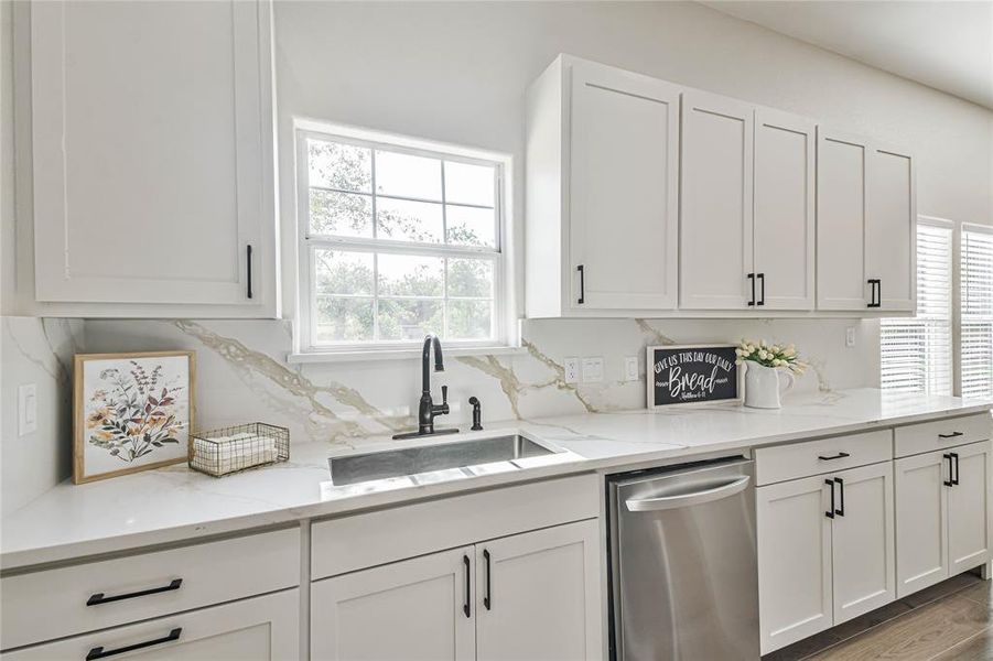 Stainless steel appliances and deep double sink with a window that allows lots of natural light in.