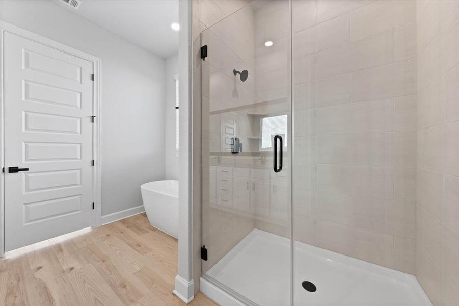 Master bathroom includes granite countertop, elongated mirror, and dual-vanity sinks. Relax in the large soaking tub or enjoy the spacious, standing shower.