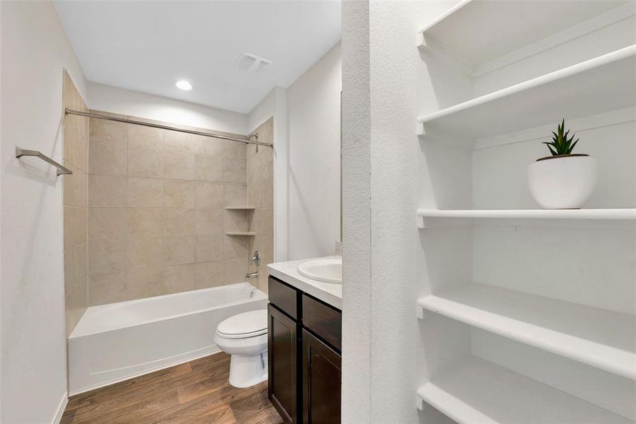 The secondary bath upstairs has plenty of storage. Relax in the tub after a long walk in the neighborhood parks and walking trails or take a quick shower after working out at the gym.