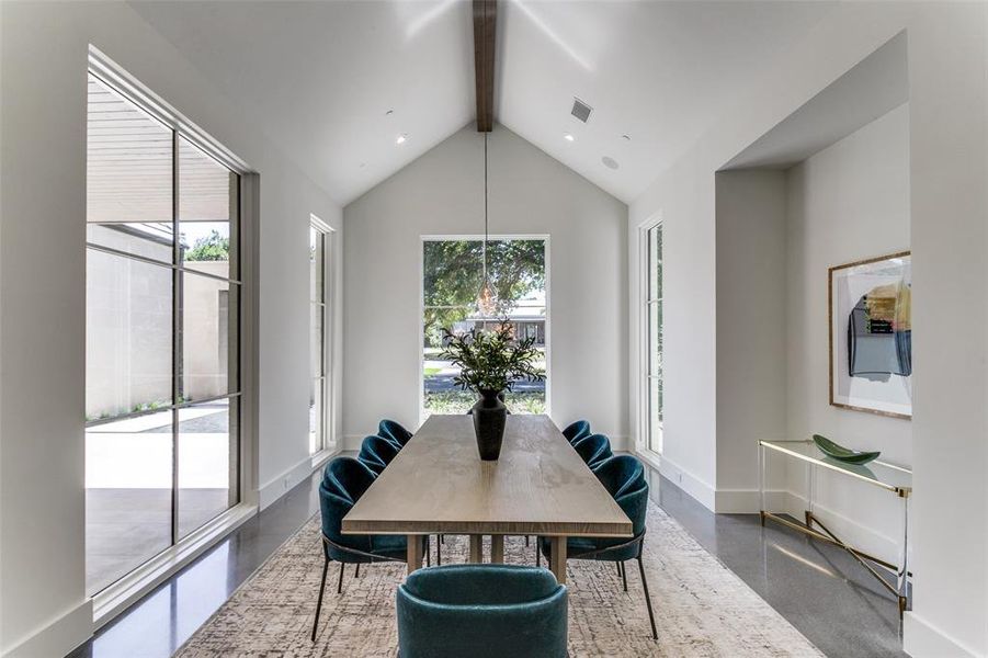 Dining room featuring beam ceiling and high vaulted ceiling