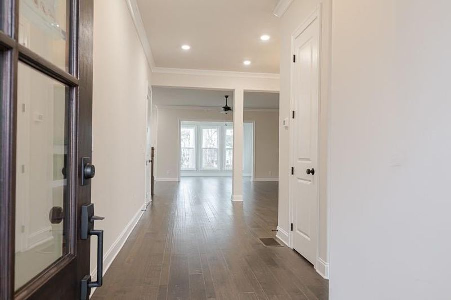 Upon entering from the spacious front porch, you're greeted by a full bedroom and bath on the main level.  Photo not actual home, but previously built Mansfield plan.